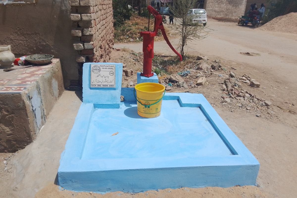A hand pump being tested after boring in a rural village in Sindh