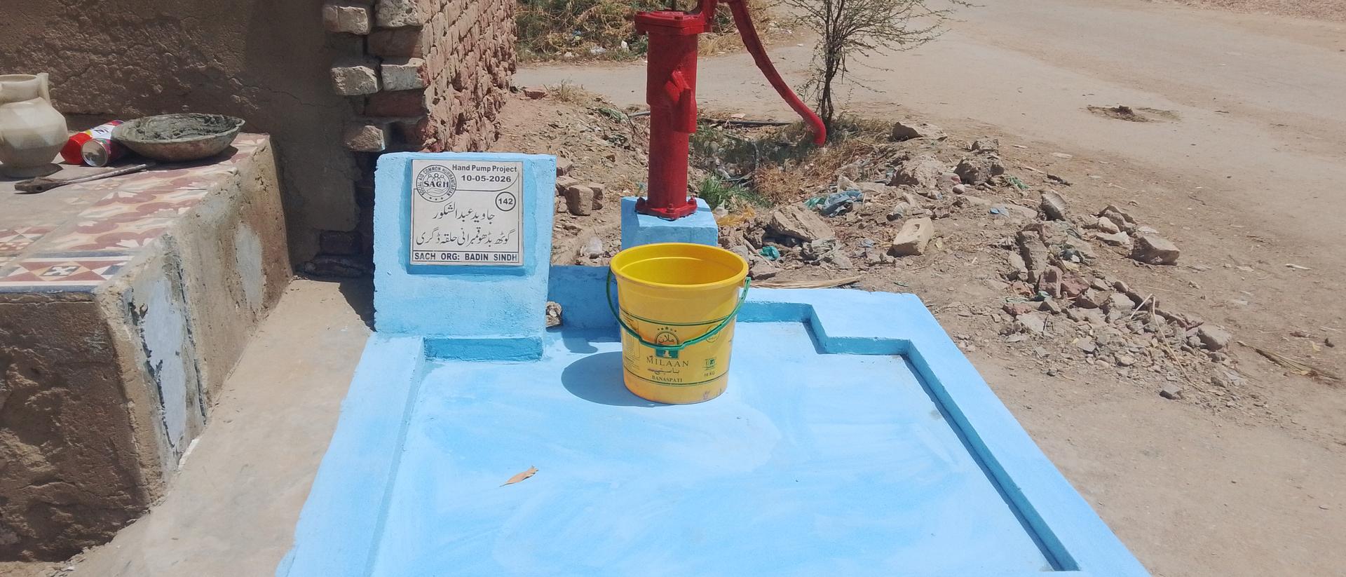 A newly installed SACH hand pump providing clean water to a rural village in Sindh, Pakistan